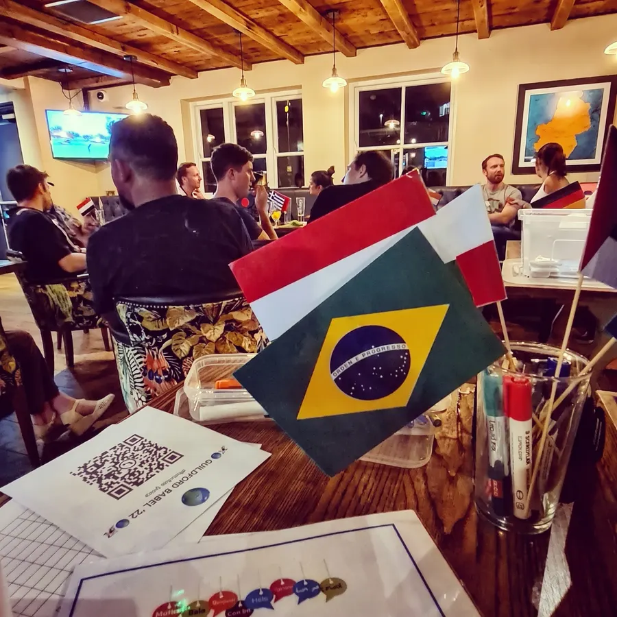 Flags of Brazil, Italy and more on a table at a Guildford Babel evening